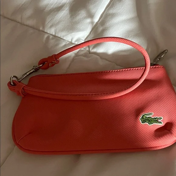 Coral color Lacoste Women's Vibrant Coral Wristlet - Picture 1 of 5
